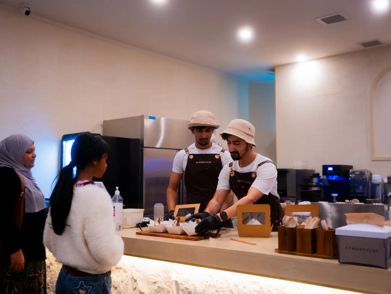 Atmosphere staff serving customers at the counter