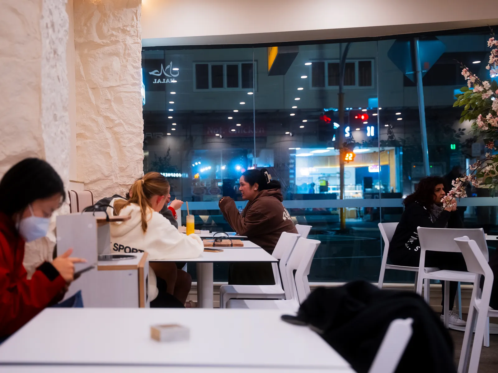 Guests enjoying a late night at Atmosphere, the Newmarket street through the window