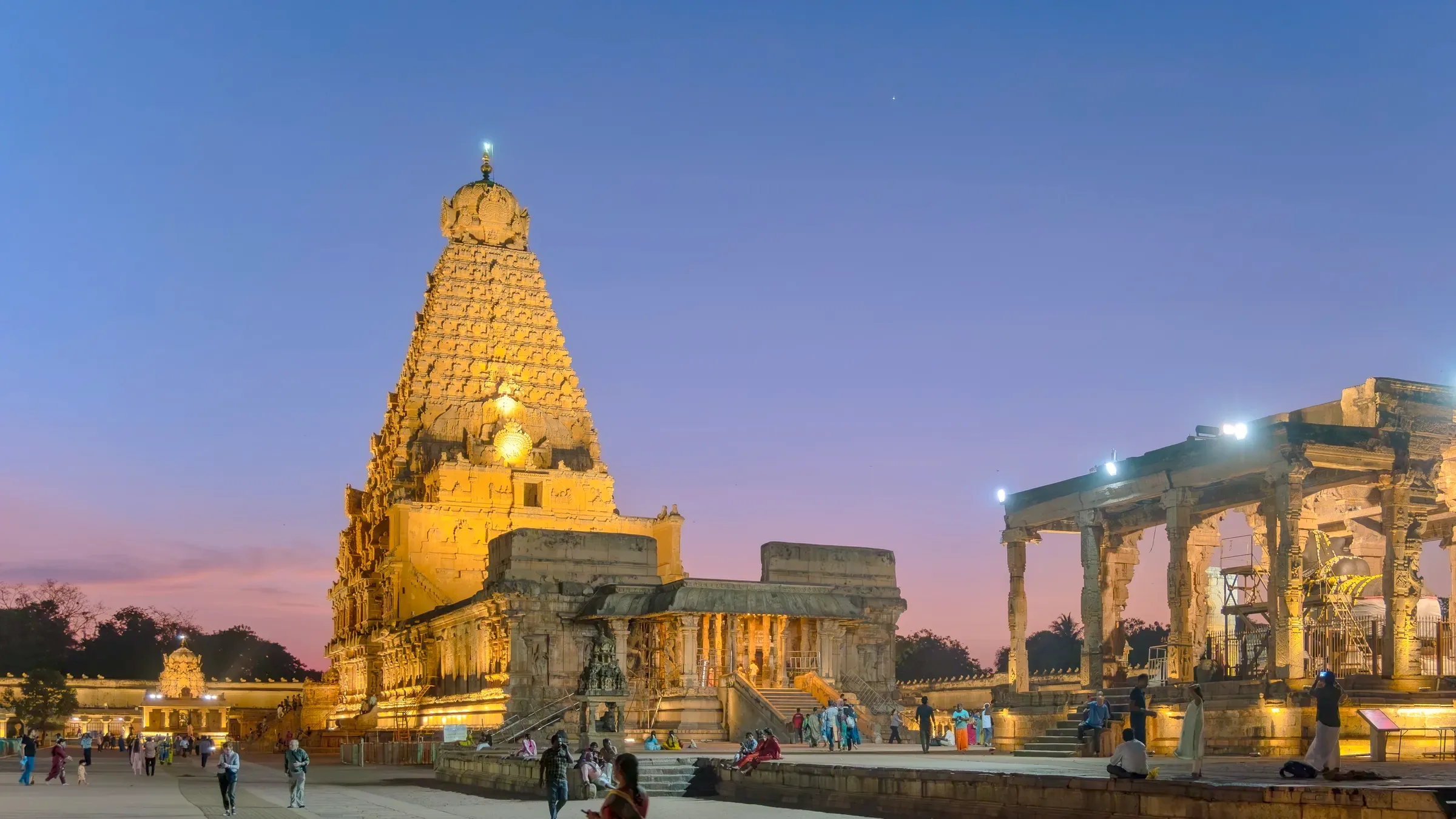 The Brihadisvara Temple in Thanjavur, its tower lit gold against the evening sky